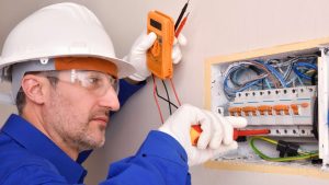 electrician testing electrical switch board